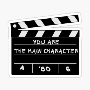 You Are the Main Character sticker featuring a black and white movie clapperboard with motivational lettering.