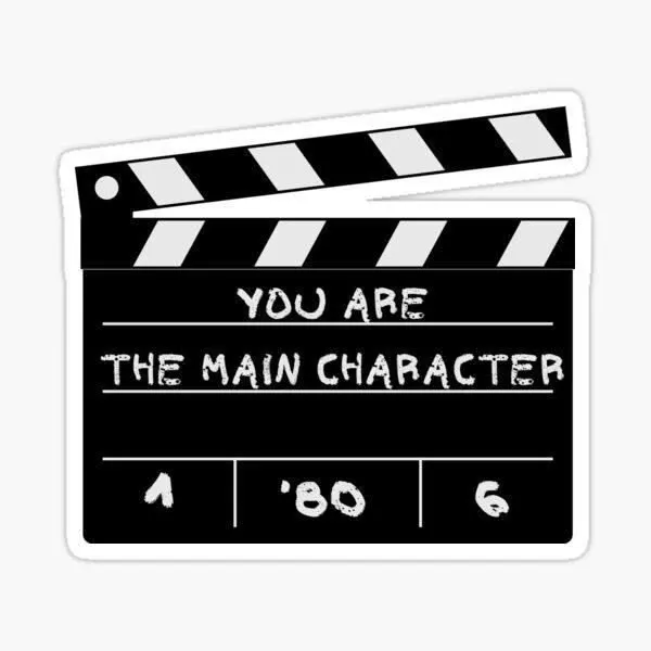 You Are the Main Character sticker featuring a black and white movie clapperboard with motivational lettering.